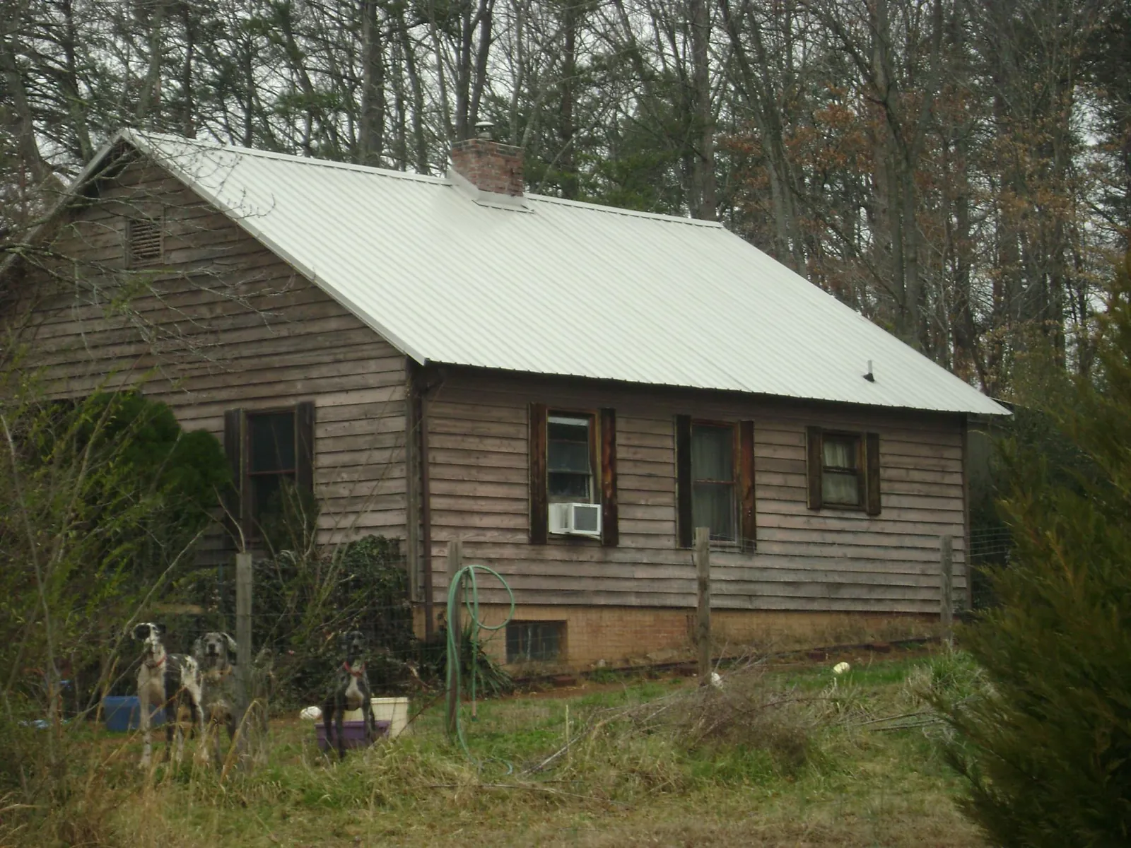 White metal roof on an old wood sided farmhouse, from a Asphalt Shingle Roof Repair job in Albemarle